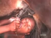 Ebony slut giving blowjob to horse before having horse sex